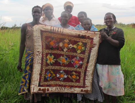 A mixture of African print, batiks and dyed fabrics in colors of brown and maroon.