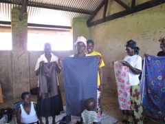 Ladies displaying some of their "American" material they received.