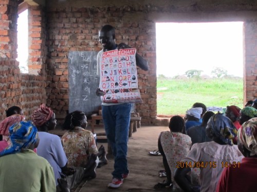 Learning the English alphabet which has a few more letters than Acholi alphabet. 